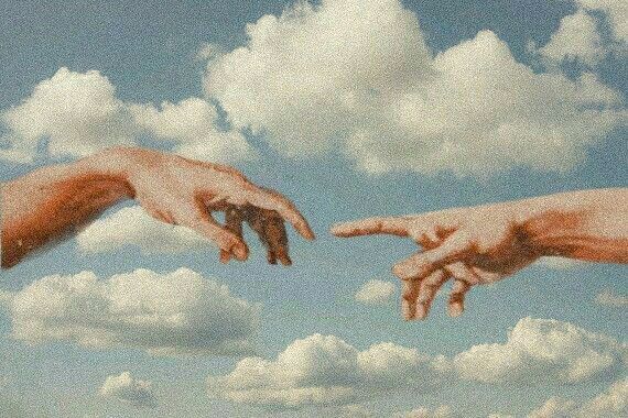 two hands reaching toward each other across a sky