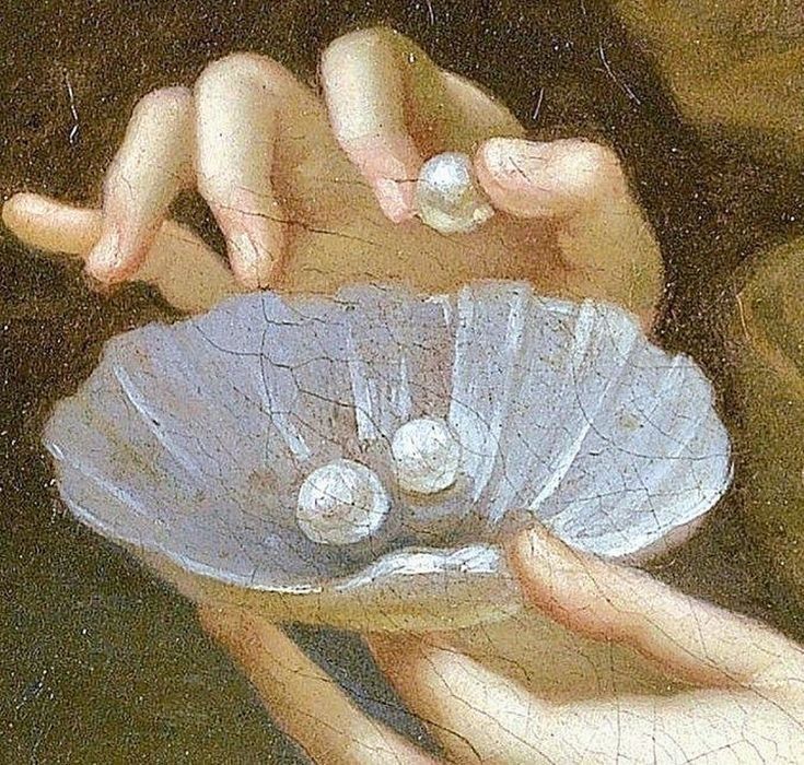 hands gathering pearls into a shell