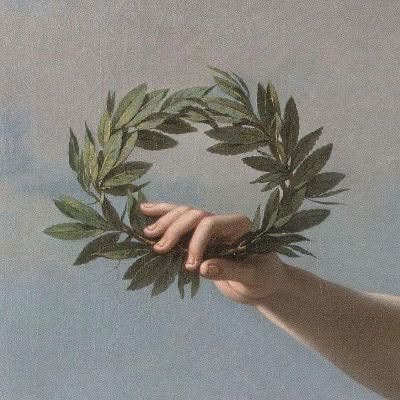 a hand holding a laurel wreath